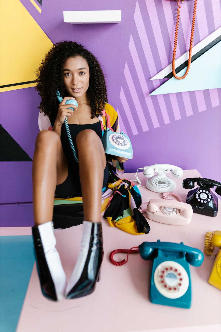 woman sitting with telephones