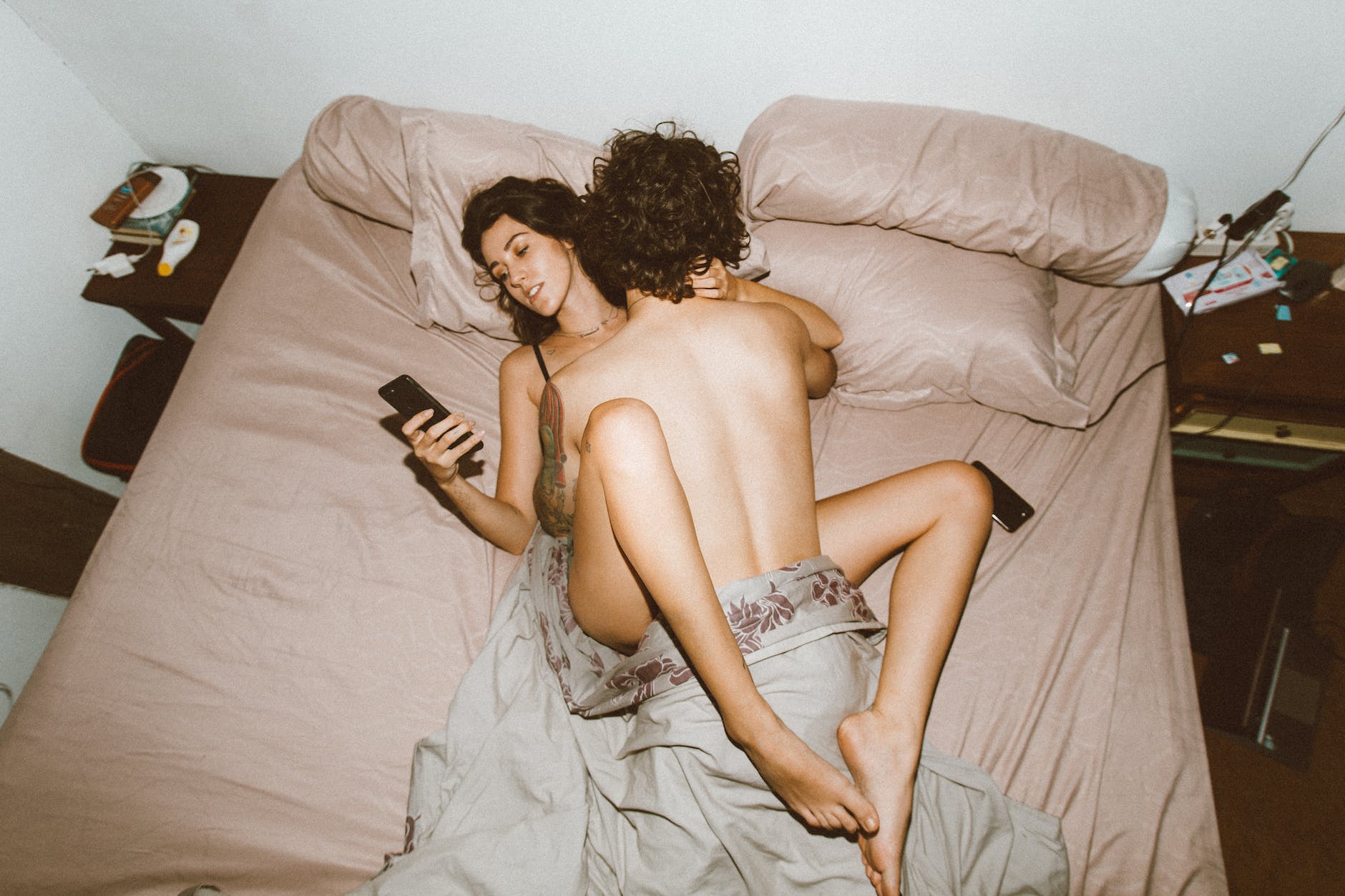 couple having sex and using smartphone